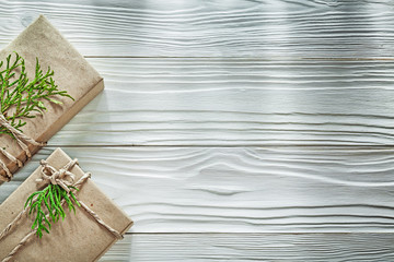 Handmade boxed gifts with thuya branch on wooden board