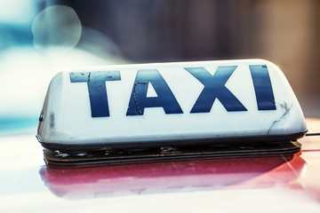 Taxi car waiting passengers in town.Taxi light on the cab of the car ready to transport the passengers
