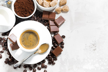 cup of espresso, ingredients and sweets and white background, top view closeup