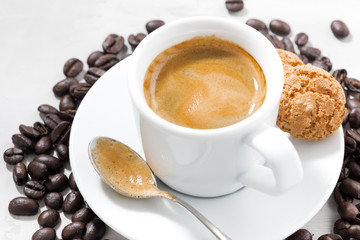 cup of fresh espresso and cookies on a white background, closeup top view