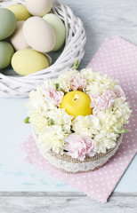 Fototapeta na wymiar Easter floral arrangement with pink and yellow carnations.