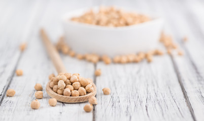 Dried Chickpeas on wooden background; selective focus