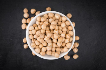 Rustic slate slab with dried Chickpeas, selective focus © HandmadePictures