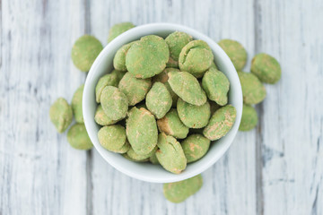 Peanuts (with Wasabi flavor) on vintage wooden background