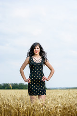 Vintage style, relaxing young woman in nature on a golden field. Rest in a meadow in the summer...