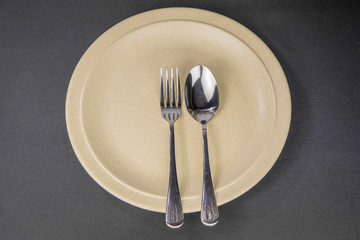 Plate , fork and spoon  isolated on black background