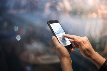 Close up male hands holding cell telephone,smartphone in night of city
