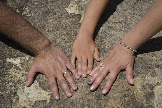 The hands of a family, father, mother and boy