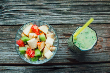 fresh fruit salad in a bowl and smoothies