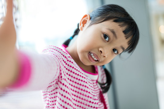 Asian Little Girl Taking Selfie