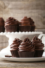 Chocolate cupcakes in plate on grey wooden table