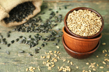 Sunflower seeds in bowl on wooden table