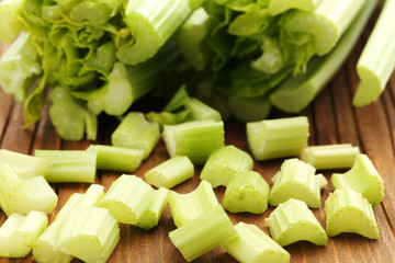 Celery on brown cutting board