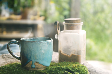 Hot Coffee cup on the wooden table in cafe natural light, vintage tone hipster style with copy space concept.