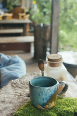 Hot Coffee cup on the wooden table in cafe natural light, vintage tone hipster style with copy space concept.