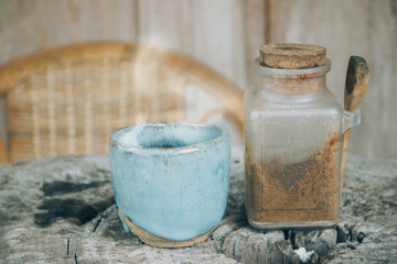 Hot Coffee cup on the wooden table in cafe natural light, vintage tone hipster style with copy space concept.