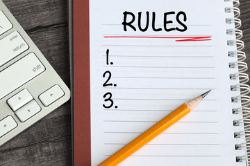 list of rules on notebook with desk background