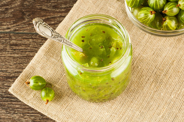 Gooseberry smoothie in a jar on a brown table