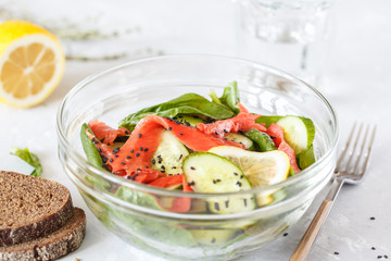 Green salad with spinach, vegetables and salted salmon