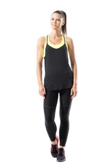 Active sporty young relaxed sportswoman in black sportswear looking at camera. Full body length portrait isolated on white background.