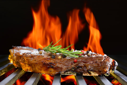  Grilled beef steak on the flaming grill
