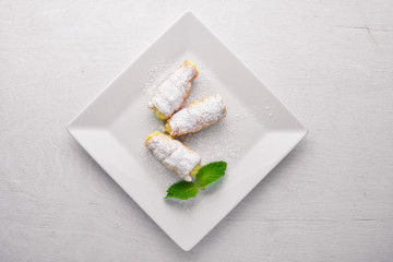Pastry with Cream. On a wooden background. Top view. Free space for your text.