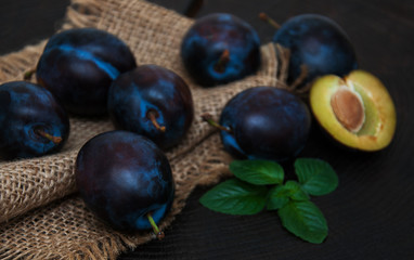 Fresh plums with green leaves