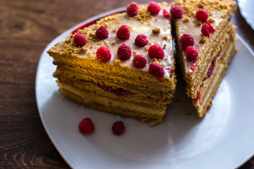 Homemade cake baking on a platter on a wooden background.