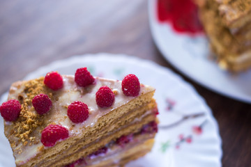 Homemade cake baking on a platter on a wooden background.
