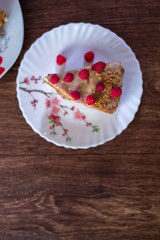 Homemade cake baking on a platter on a wooden background.