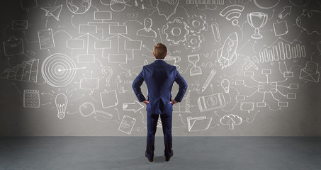 Businessman watching a project sketch on a wall 3D rendering