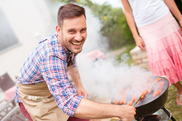 Couple on vacation having barbecue