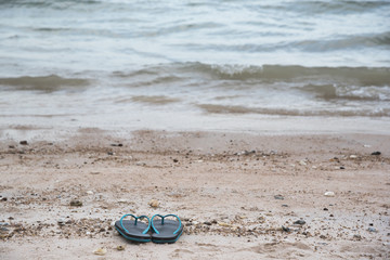 A rubber slippers on the beach