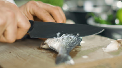 Close-up of a Chef Masterfully Cutting Fish on a Kitchen of a Famous Restaurant.