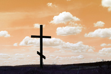 christian Cross as symbol religion against abstract sky background