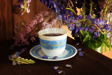 Morning coffee. Espresso on the table next to a bouquet of flowers