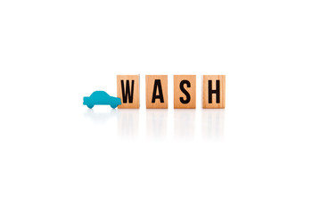 Car Wash - wooden block letters on white reflective background with blue car shape