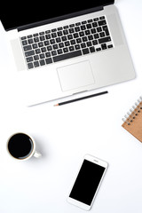 Office desktop with modern laptop on white background. Top view