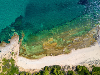 Overhead shot of sandy beach and turquoise sea