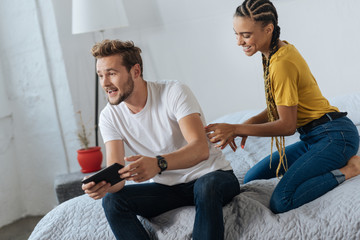 Positive delighted bearded man playing game