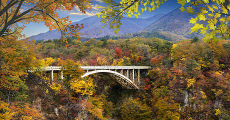 autumn colors of Naruko Gorge in Japan and nice blue and cloud background