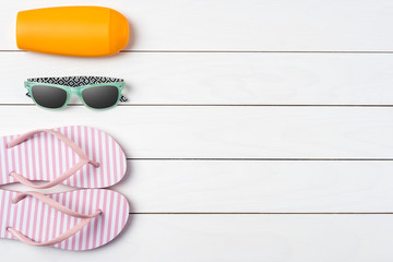 Summer accessories on white wooden table