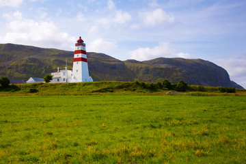 Fototapeta na wymiar Alnes lighthouse at Godoy island near Alesund, Norway