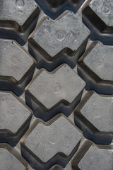 Tread pattern of black rubber tire close-up