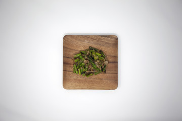 Quinoa with asparagus on square wood plate