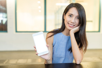 Woman showing blank screen of cellphone