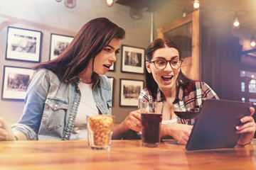 Happy female pointing at her device