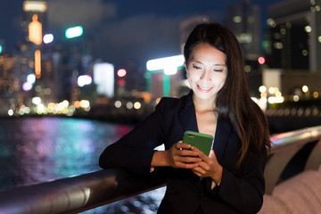 Business woman using mobile phone in Hong Kong city