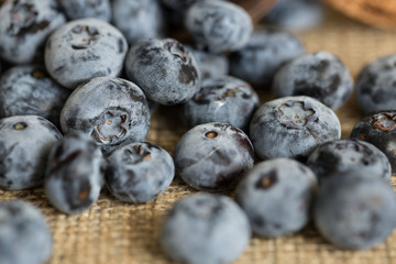 Blueberries sprinkled from rustic cup
