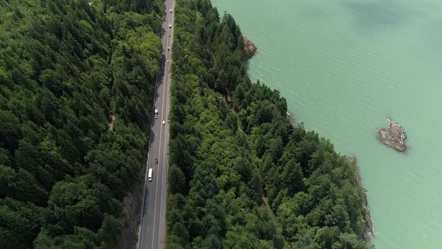 Beautiful Ocean Highway Aerial of People on Roadtrip by Green Forest and Turquoise Water